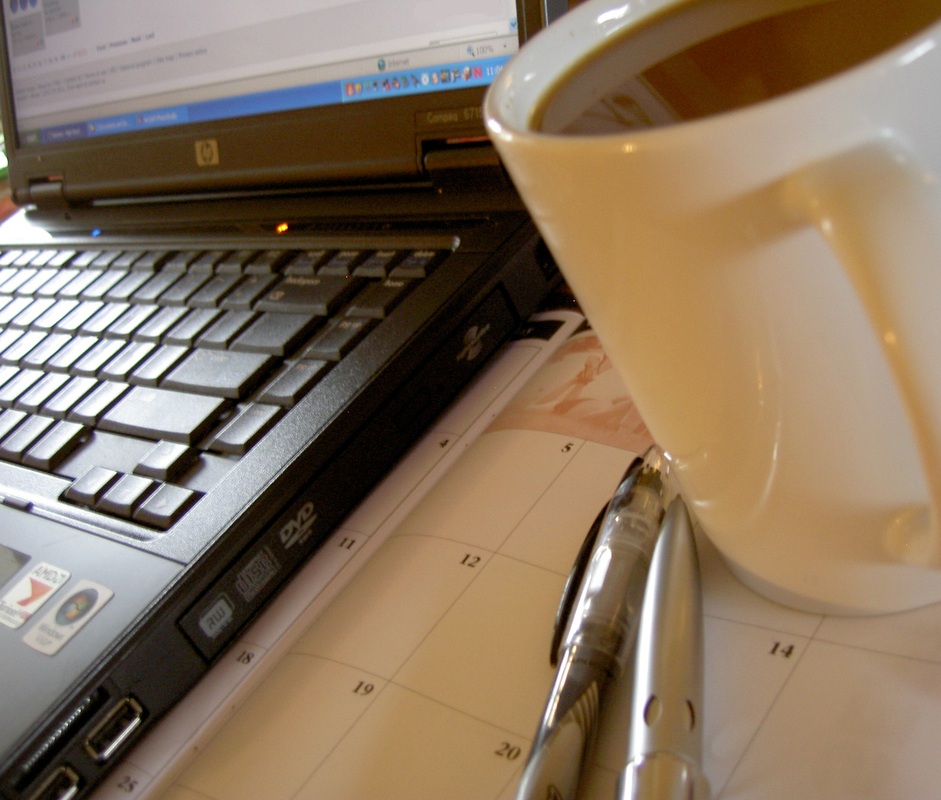 Cup of coffee next to laptop graphic